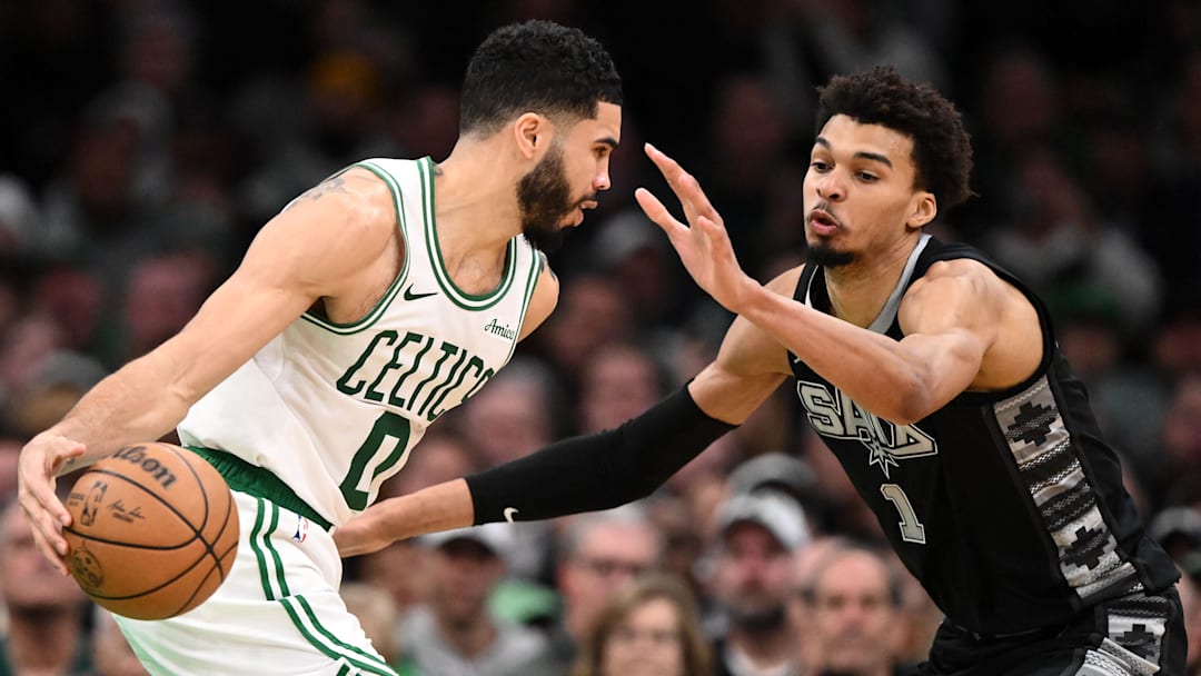 San Antonio Spurs center Victor Wembanyama (1) defends Boston Celtics forward Jayson Tatum (0) during the fourth quarter at the TD Garden. Mandatory Credit: Brian Fluharty-Imagn Images