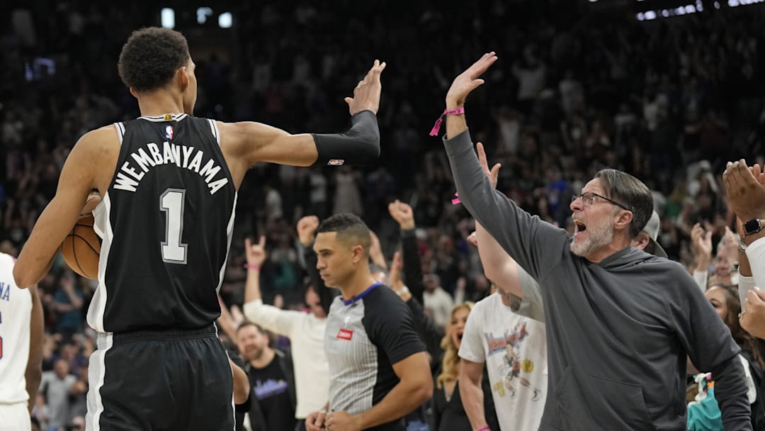 Mar 29, 2024; San Antonio, Texas, USA; San Antonio Spurs forward Victor Wembanyama (1) and a fan react after an overtime victory over the New York Knicks at Frost Bank Center. Mandatory Credit: Scott Wachter-Imagn Images