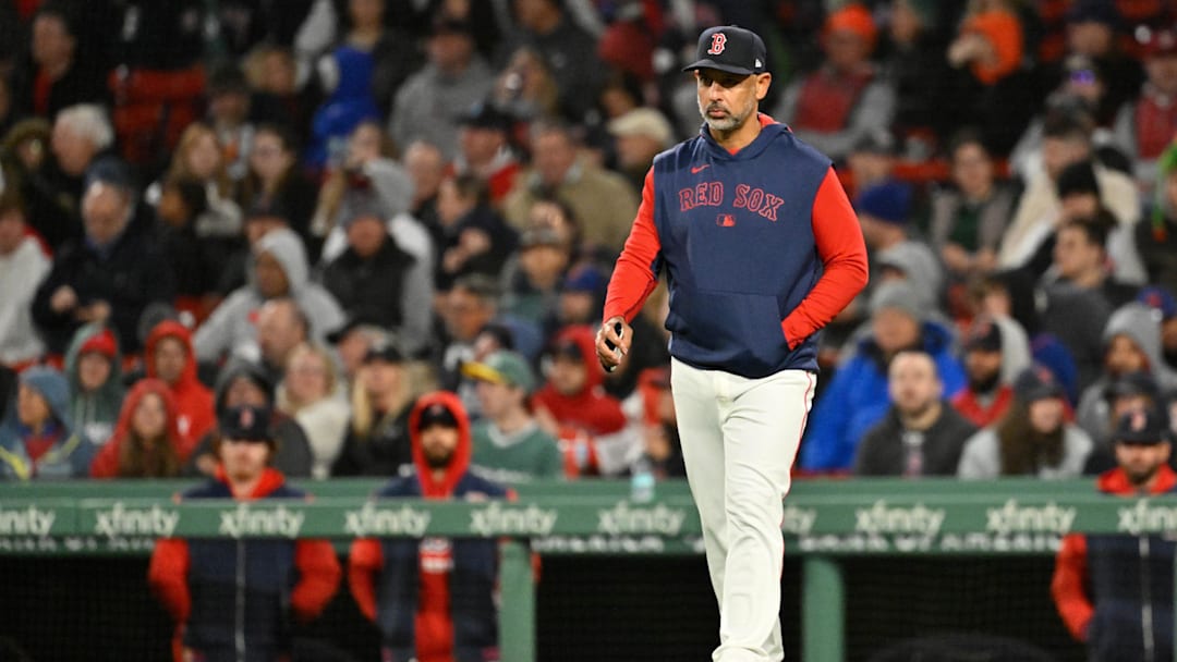 May 21, 2025; Boston, Massachusetts, USA; Boston Red Sox manager Alex Cora (13) walks to the mound during the sixth inning against the New York Mets at Fenway Park. Mandatory Credit: Eric Canha-Imagn Images