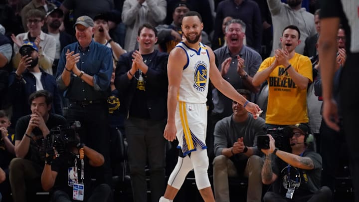 Golden State Warriors guard Stephen Curry (30) smiles after a Warriors basket against the Detroit Pistons in the fourth quarter at Chase Center.