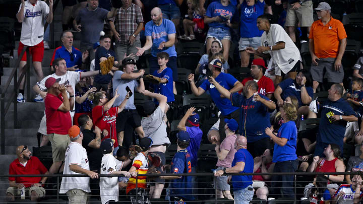 Aug 5, 2024; Arlington, Texas, USA; A view of the Texas Rangers fans as they battle for a home run ball hit by shortstop Corey Seager (not pictured) during the eighth inning against the Houston Astros at Globe Life Field. Mandatory Credit: Jerome Miron-USA TODAY Sports