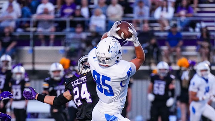 Mukwonago's Luka Tess (85) makes a catch and runs it in for a touchdown during the football game against Oconomowoc, Sept. 12, 2025, in Oconomowoc, Wisconsin. Mukwonago won the game, 35-6.