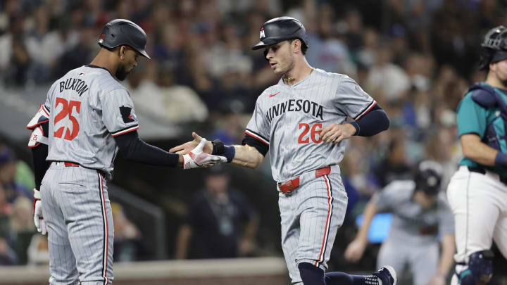 Minnesota Twins right fielder Max Kepler (26) scores and is greeted by Minnesota Twins outfielder Byron Buxton (25) during the second inning at T-Mobile Park in Seattle on June 29, 2024. 