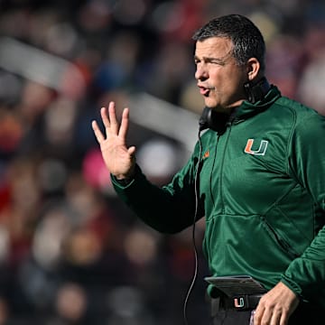 Nov 24, 2023; Chestnut Hill, Massachusetts, USA; Miami Hurricanes head coach Mario Cristobal calls a play against the Boston College Eagles during the first half at Alumni Stadium. Mandatory Credit: Brian Fluharty-Imagn Images