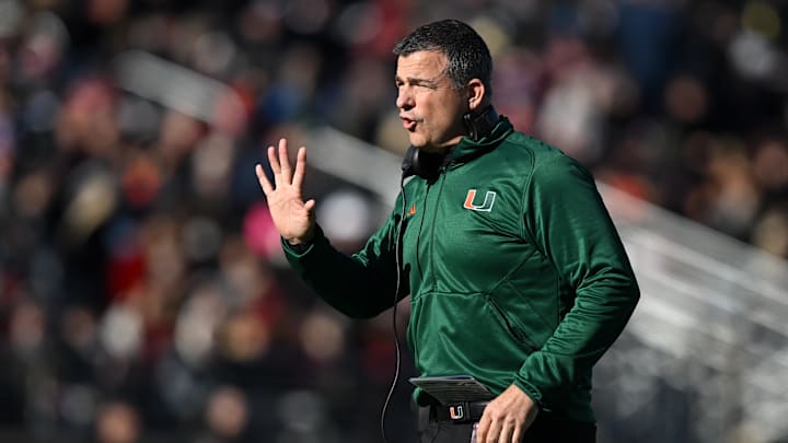 Nov 24, 2023; Chestnut Hill, Massachusetts, USA; Miami Hurricanes head coach Mario Cristobal calls a play against the Boston College Eagles during the first half at Alumni Stadium. Mandatory Credit: Brian Fluharty-Imagn Images