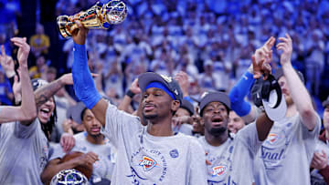 Oklahoma City Thunder guard Shai Gilgeous-Alexander celebrates with the West Conference Finals MVP trophy after defeating the Minnesota Timberwolves.