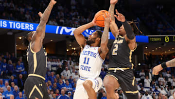 Jan 26, 2025; Memphis, Tennessee, USA; Memphis Tigers guard Tyrese Hunter (11) shoots as UAB Blazers guard Tony Toney (6) and guard Ja'Borri McGhee (2) defend during the first half at FedExForum. Mandatory Credit: Wesley Hale-Imagn Images
