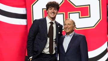 Mason West, left, was picked 29th overall by the Chicago Blackhawks in the 2025 NHL Draft over the summer. On Friday night, West and the Edina football team captured the MSHSL Class 6A Prep Bowl title. Also pictured is NHL commissioner Gary Bettman.