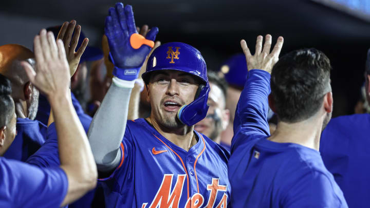 Jun 26, 2024; New York City, New York, USA;  New York Mets right fielder Tyrone Taylor (15) is greeted in the dugout after hitting a three run home run in the sixth inning against the New York Yankees at Citi Field. Mandatory Credit: Wendell Cruz-USA TODAY Sports