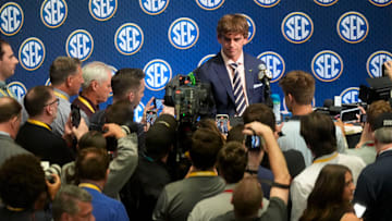 Texas quarterback Arch Manning is surrounded by media as he participates in SEC Media Days at the College Football Hall of Fame in Atlanta.