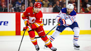 Nov 3, 2024; Calgary, Alberta, CAN; Calgary Flames center Yegor Sharangovich (17) and Edmonton Oilers center Leon Draisaitl (29) battles for the puck during the third period at Scotiabank Saddledome. Mandatory Credit: Sergei Belski-Imagn Images
