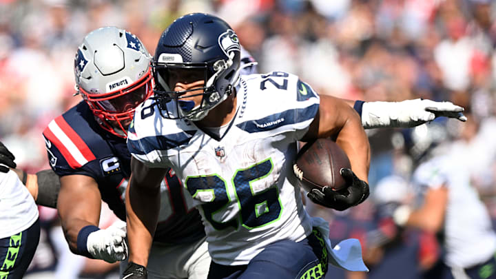 Sep 15, 2024; Foxborough, Massachusetts, USA; Seattle Seahawks running back Zach Charbonnet (26) rushes against the New England Patriots during the second half at Gillette Stadium. Mandatory Credit: Brian Fluharty-Imagn Images