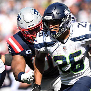 Sep 15, 2024; Foxborough, Massachusetts, USA; Seattle Seahawks running back Zach Charbonnet (26) rushes against the New England Patriots during the second half at Gillette Stadium. Mandatory Credit: Brian Fluharty-Imagn Images