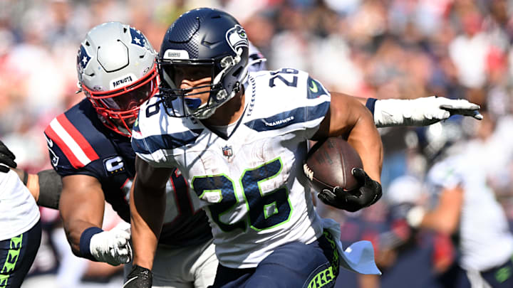 Sep 15, 2024; Foxborough, Massachusetts, USA; Seattle Seahawks running back Zach Charbonnet (26) rushes against the New England Patriots during the second half at Gillette Stadium. Mandatory Credit: Brian Fluharty-Imagn Images