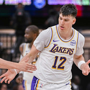 Oct 26, 2025; Sacramento, California, USA; Los Angeles Lakers forward Jake Laravia (12) high fives guard Austin Reaves (15) after scoring against the Sacramento Kings during the fourth quarter at Golden 1 Center. Mandatory Credit: Ed Szczepanski-Imagn Images