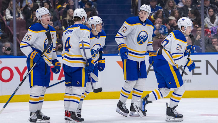 Jan 21, 2025; Vancouver, British Columbia, CAN; Buffalo Sabres defenseman Rasmus Dahlin (26) and defenseman Bowen Byram (4) and forward JJ Peterka (77) and forward Tage Thompson (72) and forward Jiri Kulich (20) celebrate Kulich’s goal against the Vancouver Canucks in the third period at Rogers Arena. Mandatory Credit: Bob Frid-Imagn Images