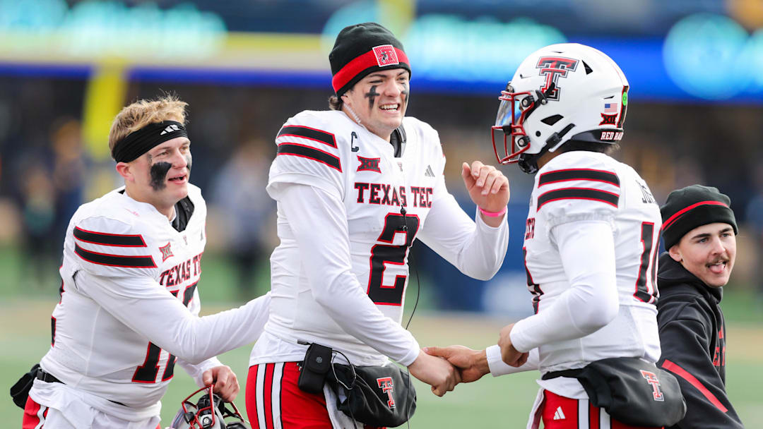 Texas Tech Red Raiders quarterback Behren Morton (2) celebrates with Texas Tech Red Raiders quarterback Lloyd Jones III (10) after a touchdown during the third quarter against the West Virginia Mountaineers at Milan Puskar Stadium. Texas Tech Red Raiders quarterback Behren Morton (2) celebrates with Texas Tech Red Raiders quarterback Lloyd Jones III (10) after a touchdown during the third quarter against the West Virginia Mountaineers at Milan Puskar Stadium.
