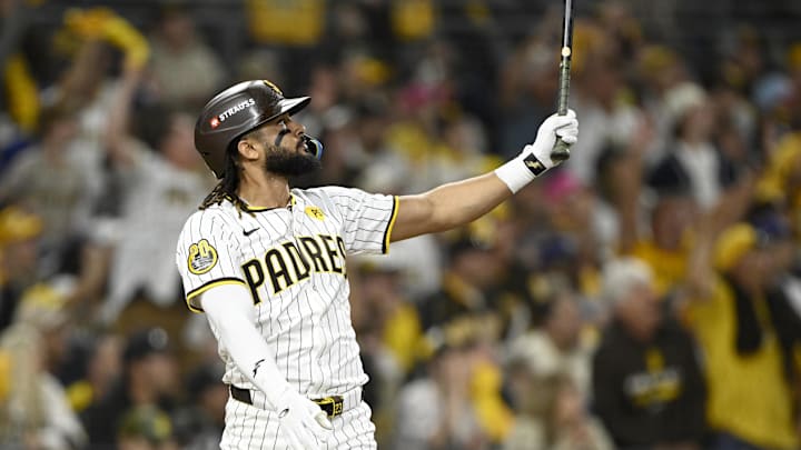 Oct 8, 2024; San Diego, California, USA; San Diego Padres outfielder Fernando Tatis Jr. (23) hits a home run in the second inning against the Los Angeles Dodgers during game three of the NLDS for the 2024 MLB Playoffs at Petco Park.  Mandatory Credit: Denis Poroy-Imagn Images