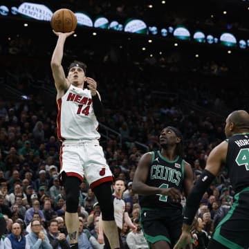 May 1, 2024; Boston, Massachusetts, USA; Miami Heat guard Tyler Herro (14) shoots as Boston Celtics guard Jrue Holiday (4) looks on during the first quarter of game five of the first round of the 2024 NBA playoffs at TD Garden. Mandatory Credit: Winslow Townson-USA TODAY Sports