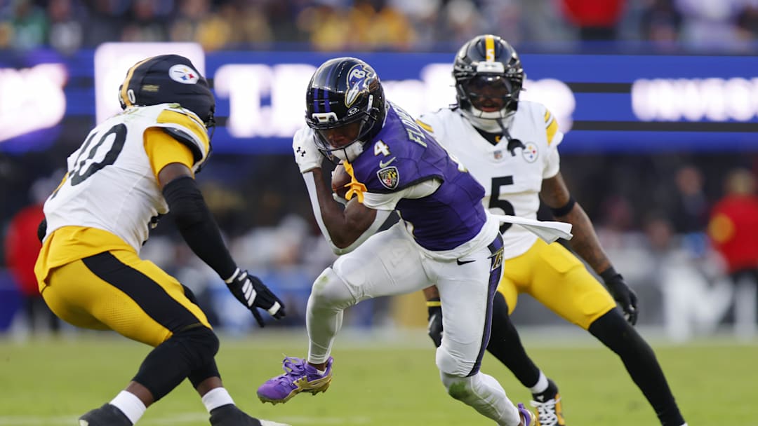 Dec 7, 2025; Baltimore, Maryland, USA; Baltimore Ravens wide receiver Zay Flowers (4) runs with the ball after making a catch against the Pittsburgh Steelers during the second half at M&T Bank Stadium. Mandatory Credit: Peter Casey-Imagn Images
