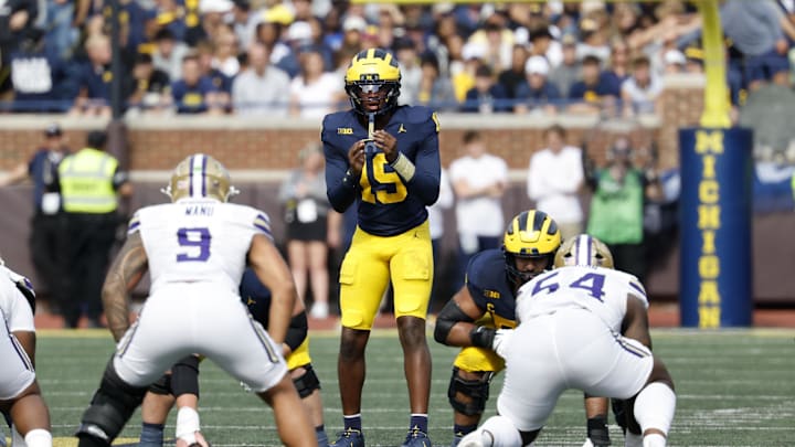 Oct 18, 2025; Ann Arbor, Michigan, USA;  Michigan Wolverines quarterback Bryce Underwood (19) gets set to run a play in the first half against the Washington Huskies at Michigan Stadium. Mandatory Credit: Rick Osentoski-Imagn Images
