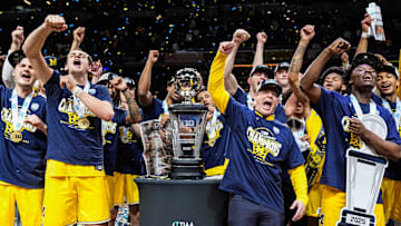 Michigan head coach Dusty May, center right, and players sing the Michigan fight song to celebrate winning the Big Ten tournament championship on Sunday, March 16, 2025, at Gainbridge Fieldhouse in Indianapolis.