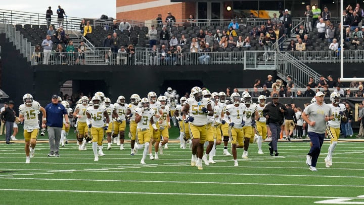 Sep 23, 2023; Winston-Salem, North Carolina, USA; Georgia Tech Yellow Jackets take the field led by head coach Brent Key during the first half against the Wake Forest Demon Deacons at Allegacy Federal Credit Union Stadium. Mandatory Credit: Jim Dedmon-USA TODAY Sports