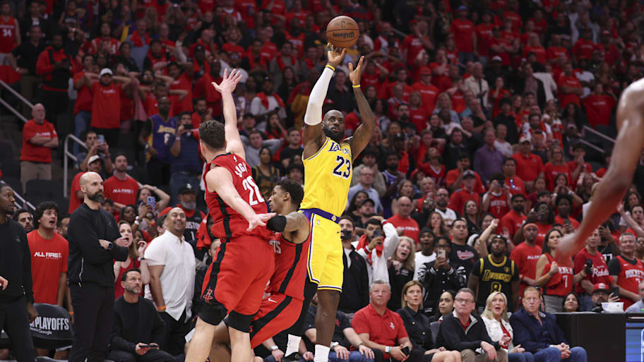 Los Angeles Lakers forward LeBron James scores a three-point basket late in the fourth quarter against the Houston Rockets.