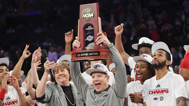 FAU head coach Dusty May raises the East Regional Champion trophy following their 79-76 victory over Kansas State.
