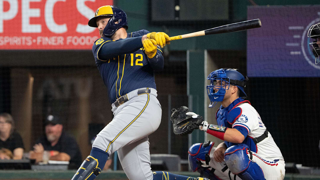 Sep 10, 2025; Arlington, Texas, USA; Milwaukee Brewers first baseman Rhys Hoskins (12) follows through on his RBI single against the Texas Rangers during the sixth inning at Globe Life Field. Mandatory Credit: Jim Cowsert-Imagn Images Sep 10, 2025; Arlington, Texas, USA; Milwaukee Brewers first baseman Rhys Hoskins (12) follows through on his RBI single against the Texas Rangers during the sixth inning at Globe Life Field. Mandatory Credit: Jim Cowsert-Imagn Images