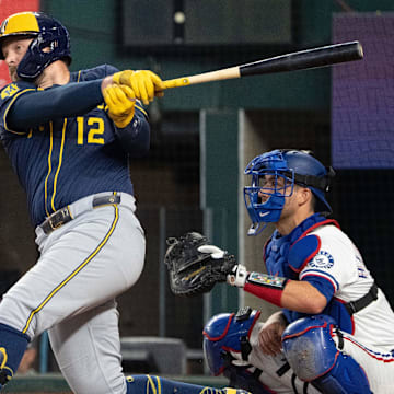 Sep 10, 2025; Arlington, Texas, USA; Milwaukee Brewers first baseman Rhys Hoskins (12) follows through on his RBI single against the Texas Rangers during the sixth inning at Globe Life Field. Mandatory Credit: Jim Cowsert-Imagn Images