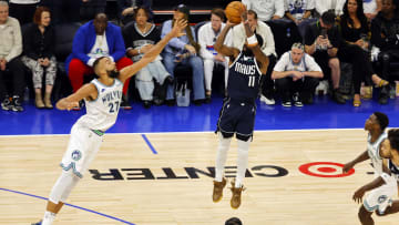 May 22, 2024; Minneapolis, Minnesota, USA; Dallas Mavericks guard Kyrie Irving (11) shoots against Minnesota Timberwolves center Rudy Gobert (27) in the fourth quarter during game one of the western conference finals for the 2024 NBA playoffs at Target Center. Mandatory Credit: Bruce Kluckhohn-USA TODAY Sports