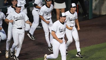 The Vanderbilt dugout runs to the field after winning a NCAA baseball game between the Tennessee Volunteers and Vanderbilt Commodores at Lindsey Nelson Stadium on May 11, 2025. Vanderbilt won 7-5 against Tennessee.