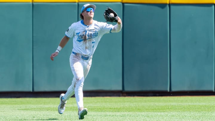 Jun 14, 2024; Omaha, NE, USA; North Carolina Tar Heels center fielder Vance Honeycutt (7) gets an out during the eighth inning against the Virginia Cavaliers at Charles Schwab Filed Omaha. Mandatory Credit: Dylan Widger-USA TODAY Sports