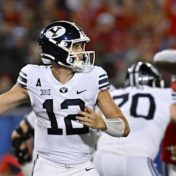 Sep 6, 2024; Dallas, Texas, USA; Brigham Young Cougars quarterback Jake Retzlaff (12) passes the ball against the Southern Methodist Mustangs during the second half at Gerald J. Ford Stadium. Mandatory Credit: Jerome Miron-Imagn Images