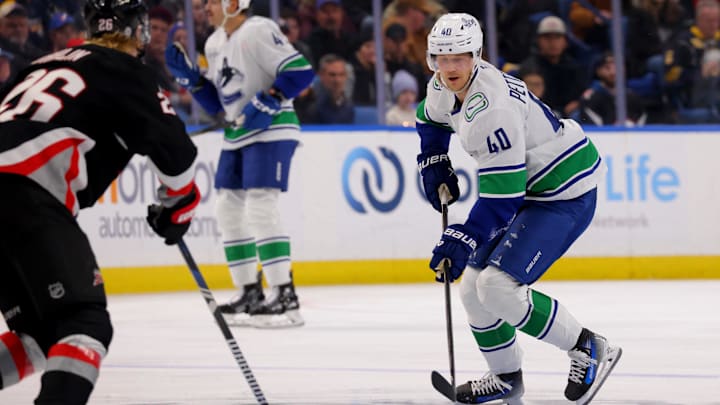 Nov 29, 2024; Buffalo, New York, USA;  Vancouver Canucks center Elias Pettersson (40) skates with the puck during the third period against the Buffalo Sabres at KeyBank Center. Mandatory Credit: Timothy T. Ludwig-Imagn Images