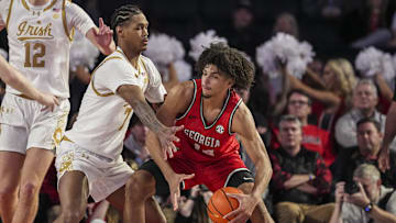 Dec 3, 2024; Athens, Georgia, USA; Georgia Bulldogs forward Asa Newell (14) controls the ball against Notre Dame Fighting Irish forward Tae Davis (7) during the second half at Stegeman Coliseum. Mandatory Credit: Dale Zanine-Imagn Images
