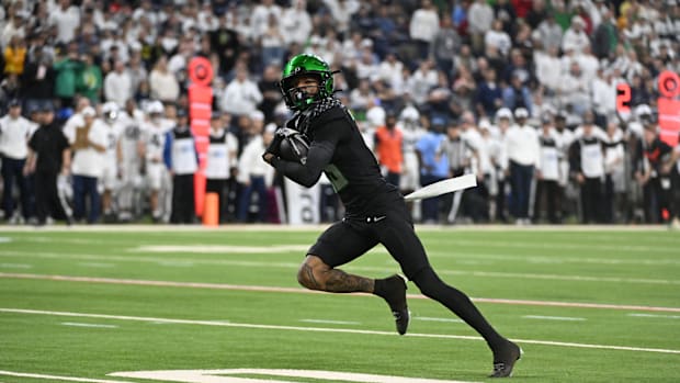 Dec 7, 2024; Indianapolis, IN, USA; Oregon Ducks wide receiver Tez Johnson (15) runs for a gain against the Penn State Nittan
