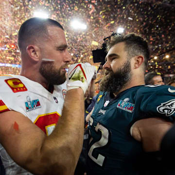 Feb 12, 2023; Glendale, Arizona, US; Kansas City Chiefs tight end Travis Kelce (87) talks with his brother Philadelphia Eagles center Jason Kelce (62) after Super Bowl LVII at State Farm Stadium. Mandatory Credit: Mark J. Rebilas-Imagn Images