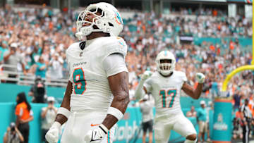 Nov 17, 2024; Miami Gardens, Florida, USA; Miami Dolphins tight end Jonnu Smith (9) celebrates a touchdown against the Las Vegas Raiders in the first quarter at Hard Rock Stadium. Mandatory Credit: Jim Rassol-Imagn Images