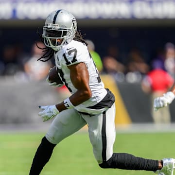 Sep 15, 2024; Baltimore, Maryland, USA; Las Vegas Raiders wide receiver Davante Adams (17) runs with the ball as Baltimore Ravens cornerback Marlon Humphrey (44) defends during the second half at M&T Bank Stadium. Mandatory Credit: Reggie Hildred-Imagn Images