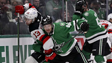 Mar 4, 2025; Dallas, Texas, USA; Dallas Stars defenseman Ilya Lyubushkin (46) checks New Jersey Devils center Nico Hischier (13) during the first period at the American Airlines Center. Mandatory Credit: Jerome Miron-Imagn Images