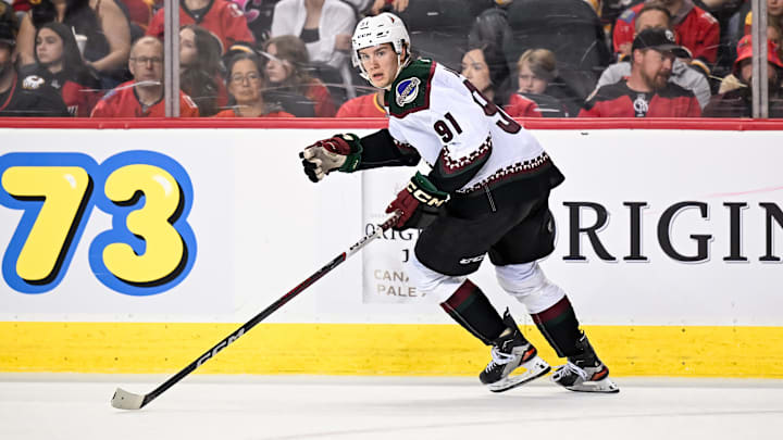 Apr 14, 2024; Calgary, Alberta, CAN; Arizona Coyotes right wing Josh Doan (91) skates against the Calgary Flames during the third period at Scotiabank Saddledome. Mandatory Credit: Brett Holmes-Imagn Images