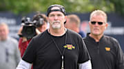 Aug 6, 2025; Foxborough, MA, USA; Washington Commanders head coach Dan Quinn walks to the podium for a press conference before training camp at Gillette Stadium. Mandatory Credit: Eric Canha-Imagn Images