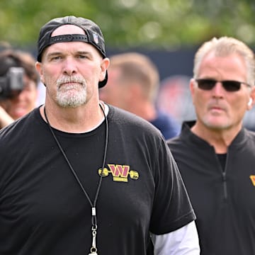 Aug 6, 2025; Foxborough, MA, USA; Washington Commanders head coach Dan Quinn walks to the podium for a press conference before training camp at Gillette Stadium. Mandatory Credit: Eric Canha-Imagn Images