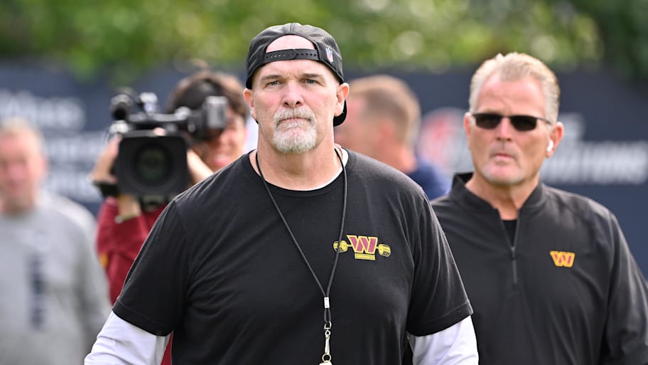 Aug 6, 2025; Foxborough, MA, USA; Washington Commanders head coach Dan Quinn walks to the podium for a press conference before training camp at Gillette Stadium. Mandatory Credit: Eric Canha-Imagn Images | Eric Canha-Imagn Images
