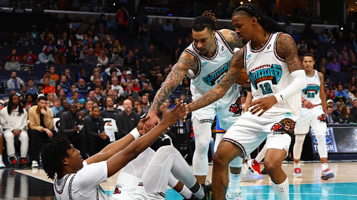 Memphis Grizzlies forward Brandon Clarke and guard Ja Morant help forward GG Jackson II during the fourth quarter