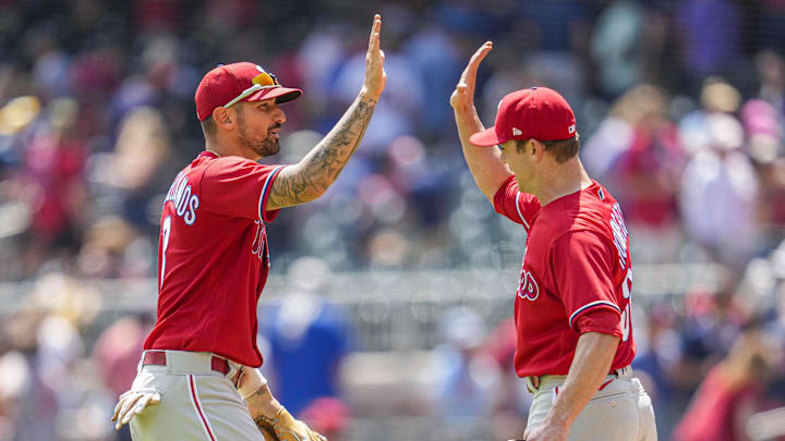 Philadelphia Phillies right fielder Nick Castellanos (8) reacts with relief pitcher David Robertson (30) the Phillies defeated the Atlanta Braves at Truist Park on Aug. 3, 2022.