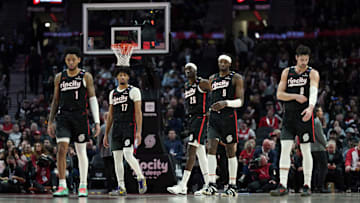 Dec 6, 2024; Portland, Oregon, USA; Portland Trail Blazers (from left to right) Anfernee Simons (1), Shaedon Sharpe (17), Duop Reath (26), Jerami Grant (9), and Deni Avdija (8) walk back to the court after a timeout during the first half against the Utah Jazz at Moda Center. Mandatory Credit: Soobum Im-Imagn Images
