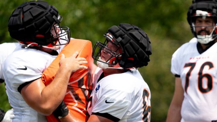 Cincinnati Bengals center Nate Gilliam (66) hits Cincinnati Bengals center Matt Lee (62) at Cincinnati Bengals training camp on the Kettering Health Practice Fields in Cincinnati on Sunday, Aug. 4, 2024.